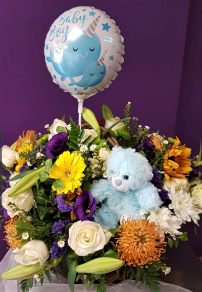 Congratulations - A basket of seasonal flowers together with a balloon and soft toy delivered door to door with your personal message - balloon greeting based on your message with your preferred colour mix.