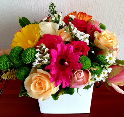 Summer Sprinkles - Mix of the best summer flowers, modern bright colours invite hope and inspiration. Will be received with enthusiasm and awe - only quality choice blooms used in this contemporary  low table arrangement