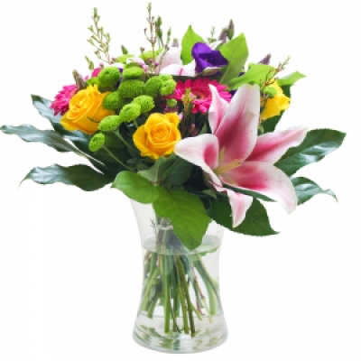 An Elegant Vase - A lovely selection of bright flowers and foliage arranged in a glass vase.
