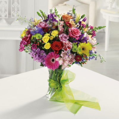 Modern Vase Arrangement - Fresh flowers selected and arranged by the florist using contemporary seasonal flowers in mixed colours finished with a swirl of chiffon . Perfect for any occasion