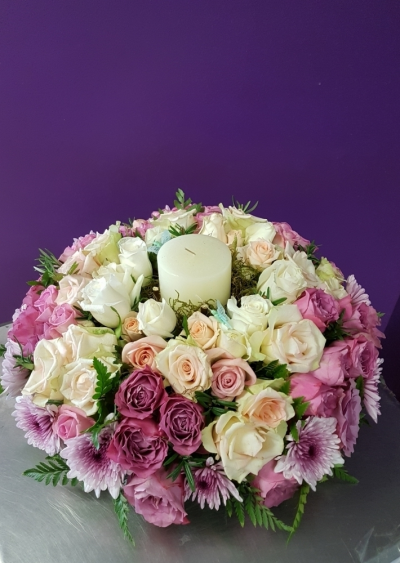 Yesterday Today Tomorrow - A celebration of beautiful mixed roses designed around a candle in honour of any occasion in the circle of life using fresh gorgeous flowers hand picked by your florist