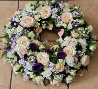 Sympathy Tribute - A collection of the freshest blooms in a traditional wreath perfect for memorials, funerals, unveilings and occasions of rememberance